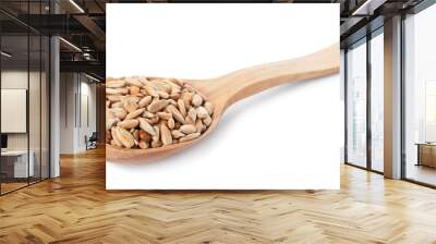 Peeled sunflower seeds in wooden spoon isolated on white Wall mural