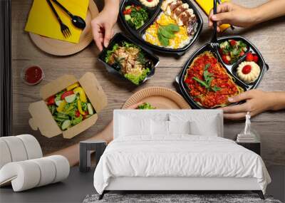 People eating healthy meals at wooden table, top view. Food delivery Wall mural