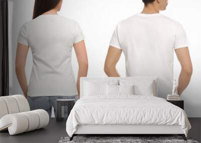 People wearing casual t-shirts on white background, back view. Mockup for design Wall mural