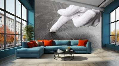 Person in white glove checking cleanliness of grey stone table, closeup Wall mural