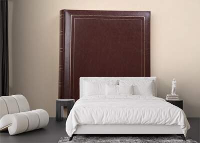 Photo album with leather cover on beige background, top view Wall mural