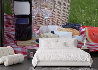 Picnic blanket with delicious food and wine outdoors on summer day, closeup Wall mural