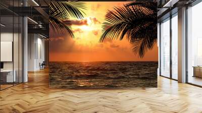 Picturesque view of sea and palm trees at sunset Wall mural