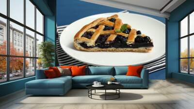 Piece of tasty homemade pie with blueberries served on blue table, closeup Wall mural