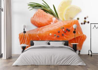 Pieces of fresh raw salmon, spices and lemon slices isolated on white, top view Wall mural