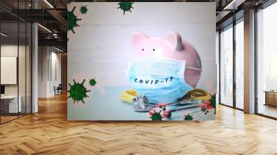 Piggy bank with medical mask. Money saving during coronavirus outbreak Wall mural