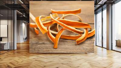 Pile of dry orange peels on wooden table Wall mural