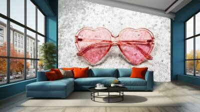 Pink heart shaped sunglasses on bright background Wall mural