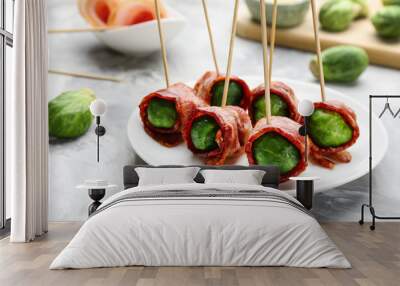 Plate with Brussels sprouts wrapped in bacon on grey table, closeup Wall mural