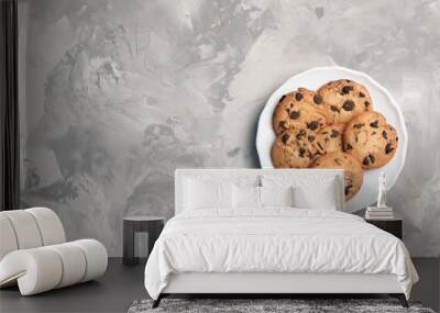 Plate with chocolate cookies and space for text on gray background, top view Wall mural