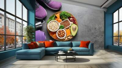 Plate with heart-healthy products and sports equipment on grey background, flat lay. Space for text Wall mural