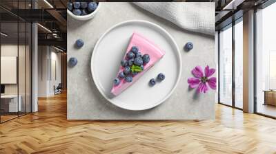 Plate with piece of tasty blueberry cake on light table, flat lay Wall mural