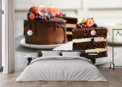 Plate with slice of chocolate sponge berry cake on grey table Wall mural