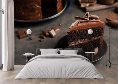 Plate with slice of tasty homemade chocolate cake on grey table. Space for text Wall mural