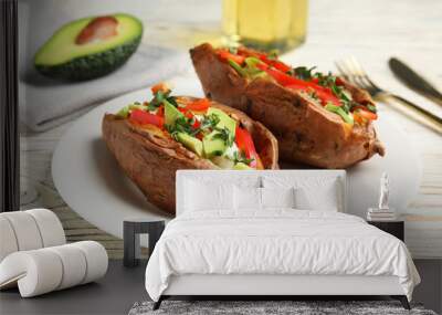 Plate with stuffed sweet potatoes on white wooden table, closeup Wall mural