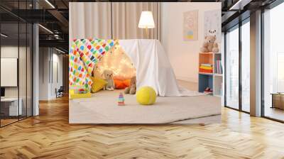 Play tent decorated with festive lights in modern child's room Wall mural