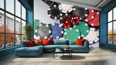 Poker chips, laptop and dices on red table, above view. Online game Wall mural