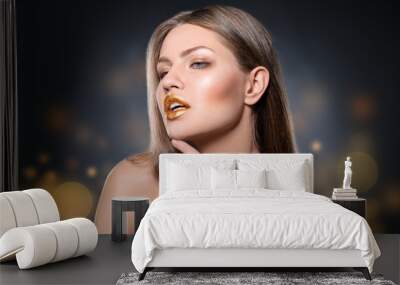 Portrait of beautiful lady with gold lipstick against blurred lights Wall mural