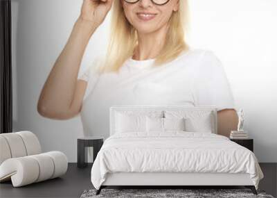 Portrait of beautiful smiling woman in glasses isolated on white Wall mural