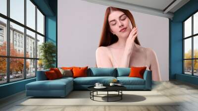 Portrait of beautiful woman on grey background. Space for text Wall mural