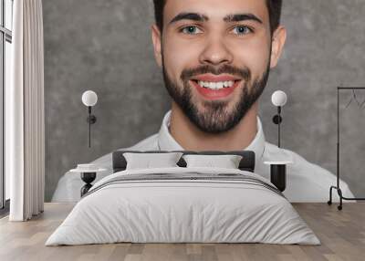 Portrait of confident businessman smiling on grey background, closeup Wall mural