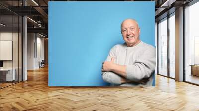 Portrait of elderly man on color background. Space for text Wall mural