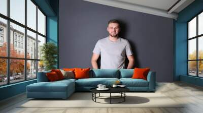 Portrait of handsome happy man on grey background Wall mural