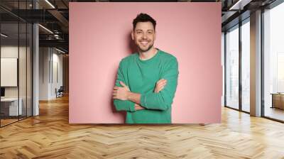 Portrait of handsome man in stylish clothes on color background Wall mural