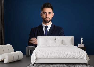 Portrait of handsome young man in office suit on color background Wall mural