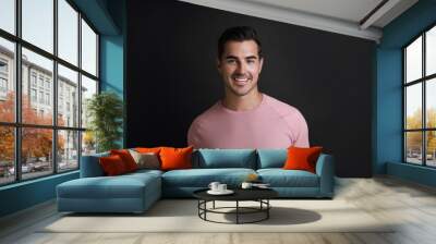 Portrait of handsome young man on black background Wall mural