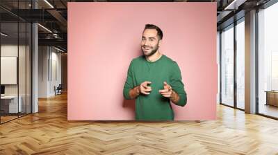 Portrait of handsome young man on color background Wall mural