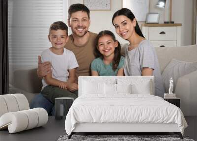 Portrait of happy family in living room. Adoption concept Wall mural