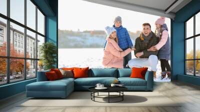 Portrait of happy family outdoors on winter day Wall mural