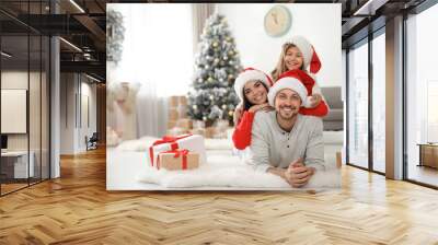 Portrait of happy family with Christmas gifts on floor at home Wall mural