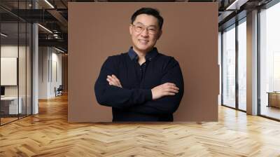 Portrait of happy man on brown background Wall mural