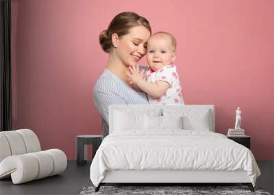 Portrait of happy mother with her baby on color background Wall mural