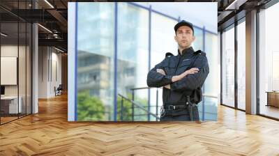 Portrait of male security guard in uniform outdoors Wall mural