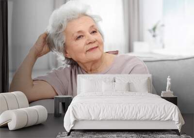 Portrait of mature woman in living room Wall mural