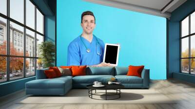 Portrait of medical assistant with stethoscope and tablet on color background. Space for text Wall mural