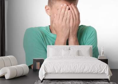 Portrait of scared young man on white background Wall mural