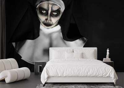 Portrait of scary devilish nun on black background, space for text. Halloween party look Wall mural