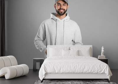 Portrait of young man in sweater on grey background. Mock up for design Wall mural