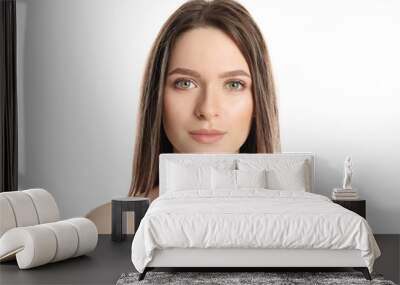 Portrait of young woman with beautiful face on white background Wall mural