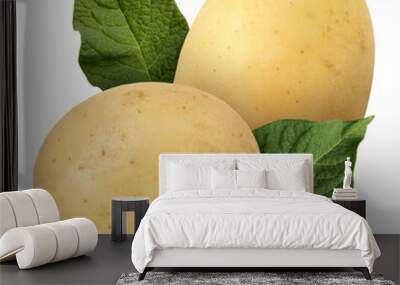 Potatoes and green leaves isolated on white Wall mural