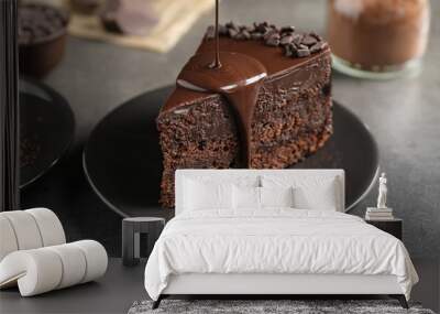 Pouring chocolate sauce onto delicious fresh cake on grey table, closeup Wall mural