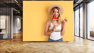 Pretty young woman with juicy watermelon on color background Wall mural