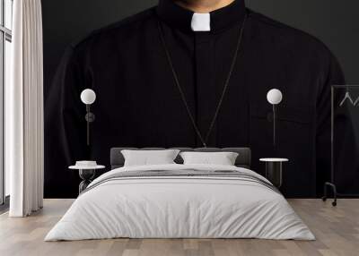 Priest with cross on black background, closeup Wall mural