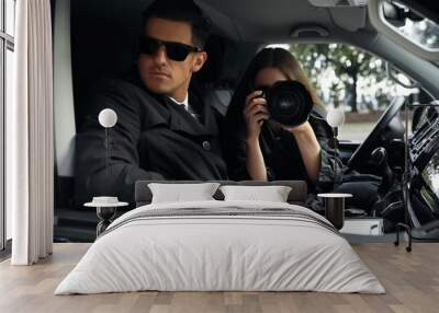 Private detectives with modern camera spying from car Wall mural