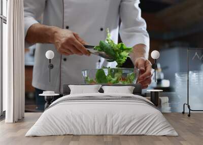 Professional chef making salad in restaurant kitchen, closeup Wall mural