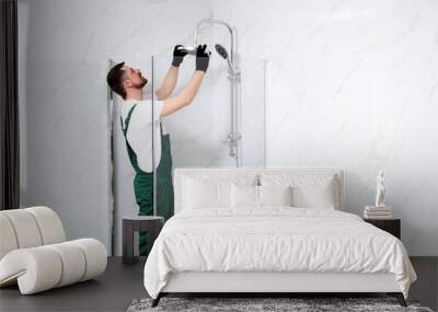 Professional handyman working in shower booth indoors, space for text Wall mural